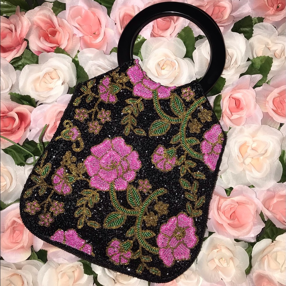 Beaded black handbag with pink and green flowers.